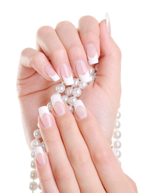 Beautiful elegant female hand with beauty french manicure over white background